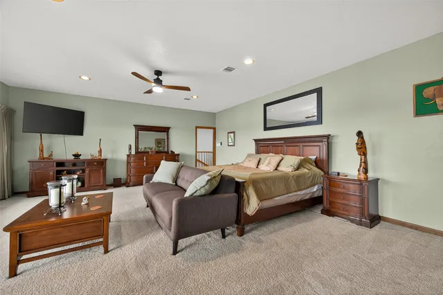 a spacious bathroom with a tub sink and mirror
