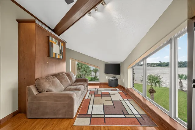 a view of a patio with wooden floor table and chairs