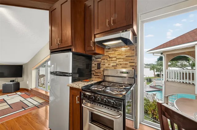 an aerial view of lake and residential houses with outdoor space