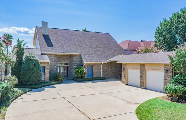 a living room with furniture large window and wooden floor