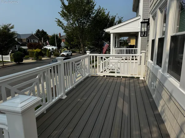 a view of balcony with wooden floor and outdoor seating