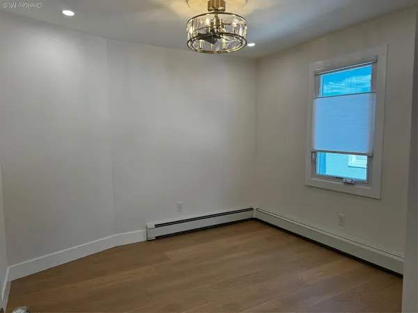 an empty room with a chandeliers