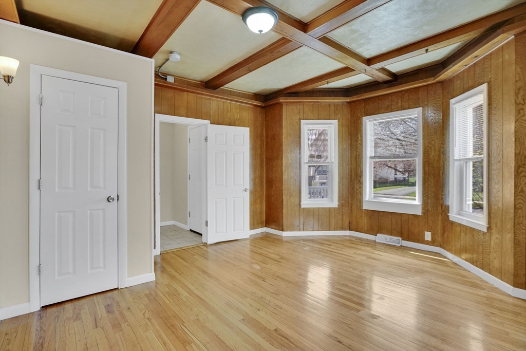 38 Whitman Street Chicopee, MA 01013 - Photo 11 of 29 a view of an empty room with wooden floor and a window