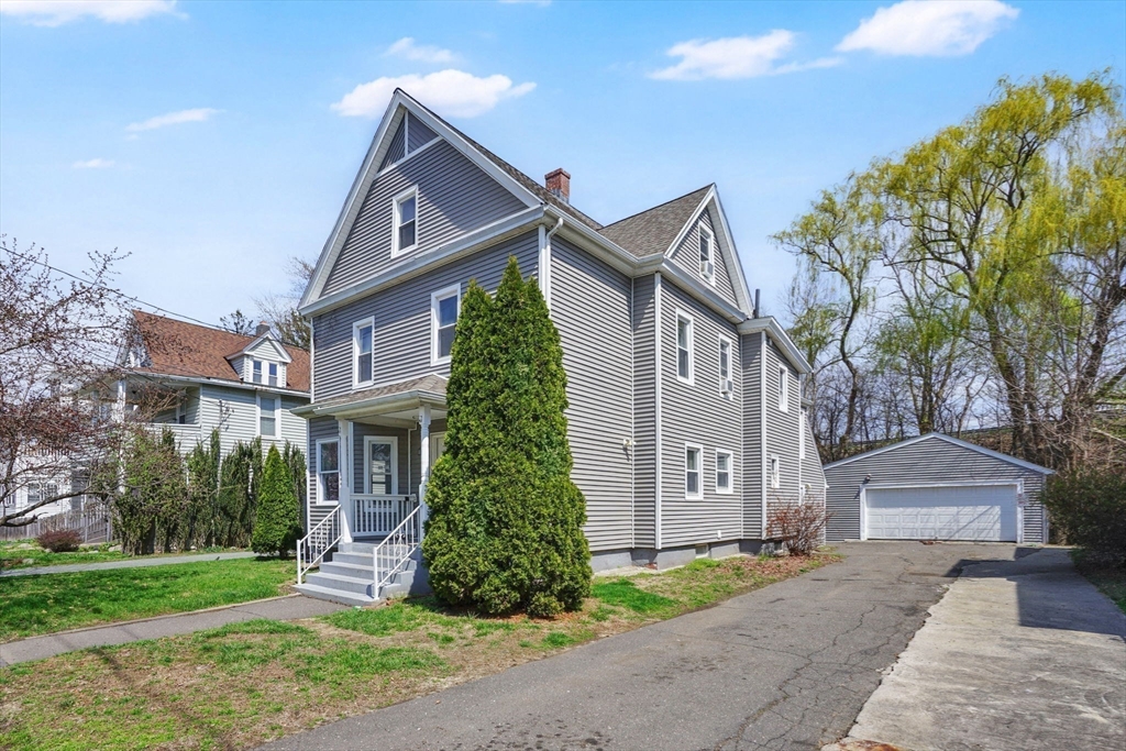 38 Whitman Street Chicopee, MA 01013 - Photo 3 of 29 a front view of a house with a yard and garage
