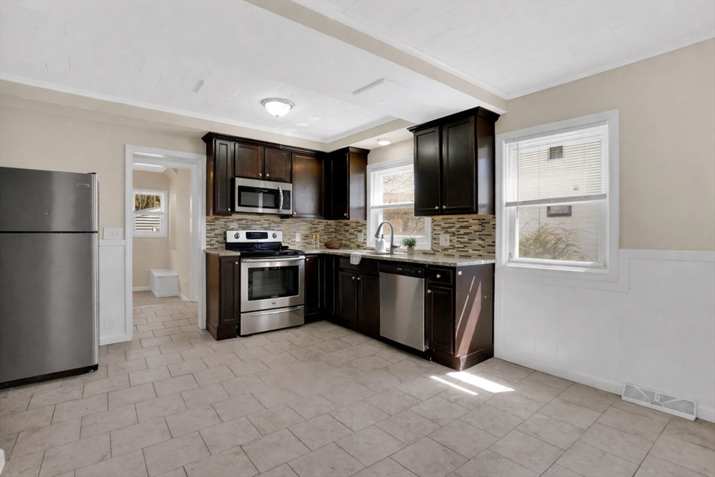 38 Whitman Street Chicopee, MA 01013 - Photo 4 of 29 a kitchen with stainless steel appliances granite countertop a stove a sink and a refrigerator