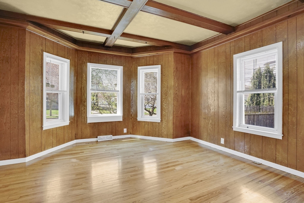 38 Whitman Street Chicopee, MA 01013 - Photo 7 of 29 a view of an empty room with wooden floor and a window