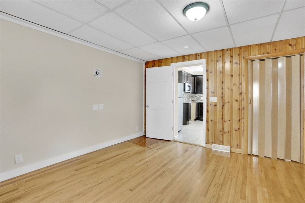 38 Whitman Street Chicopee, MA 01013 - Photo 10 of 29 a view of an empty room with wooden floor and a window