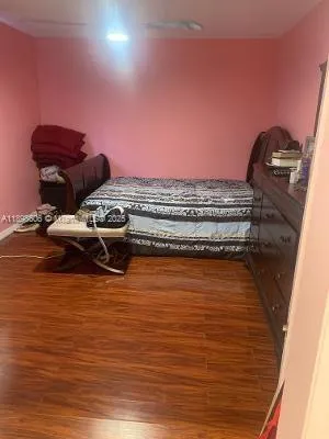 a view of a room with wooden floor