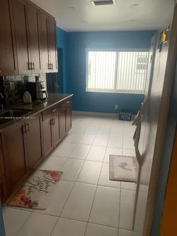 a kitchen with stainless steel appliances a sink a stove a refrigerator a window