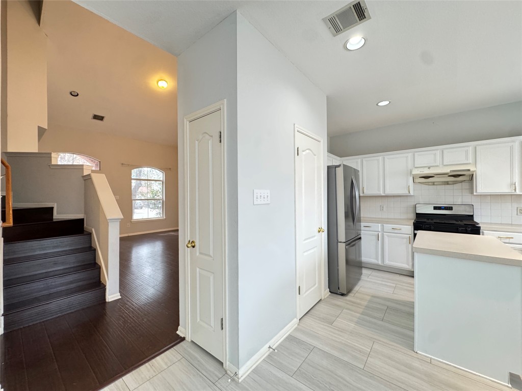 3404 Bratton Ridge Crossing Austin, TX 78728 - Photo 11 of 25 a view of a kitchen with refrigerator and wooden floor