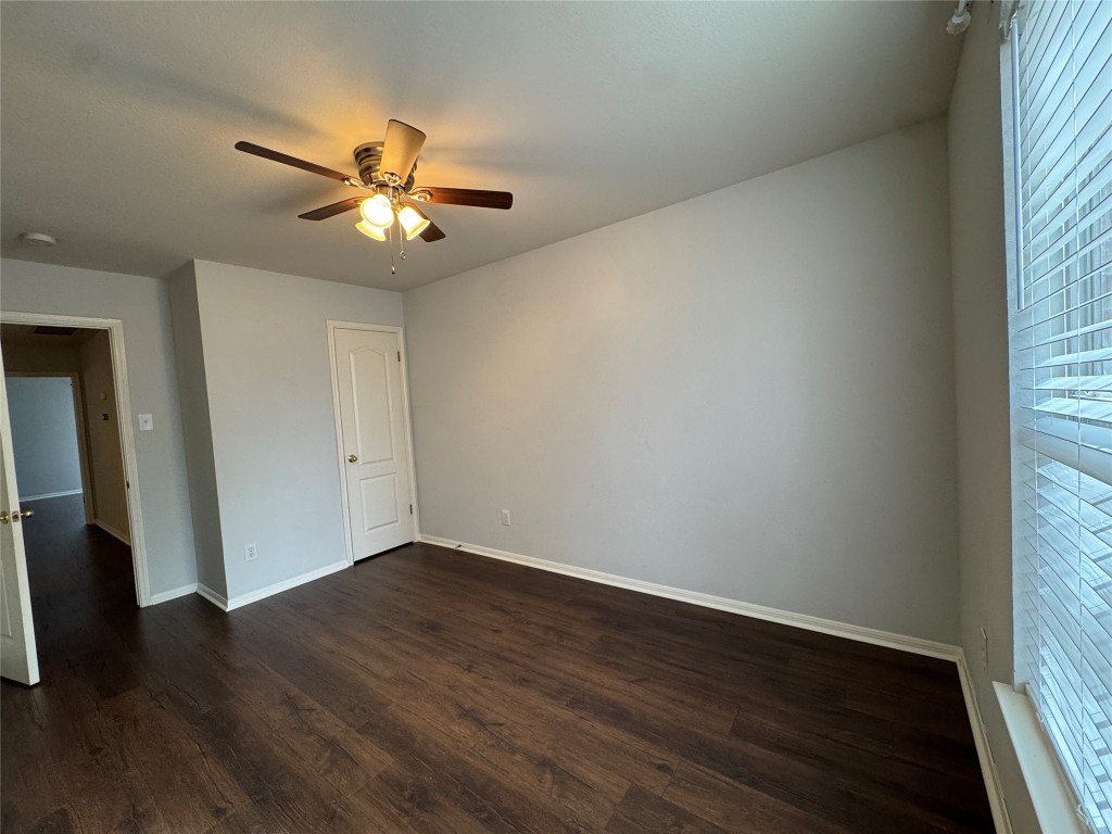 3404 Bratton Ridge Crossing Austin, TX 78728 - Photo 12 of 25 an empty room with wooden floor fan and windows