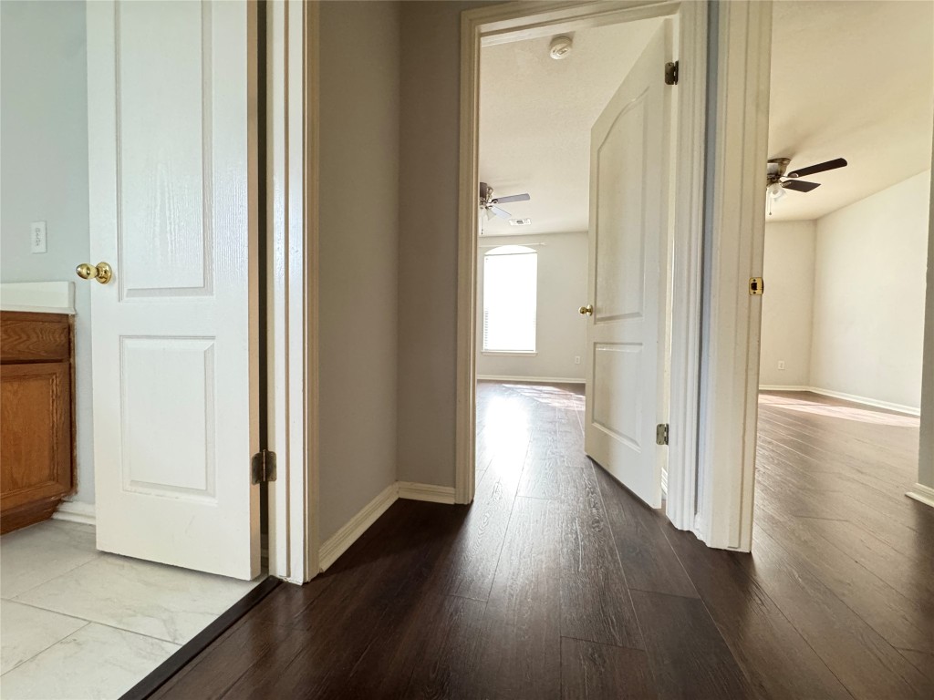 3404 Bratton Ridge Crossing Austin, TX 78728 - Photo 19 of 25 a view of a hallway with wooden floor