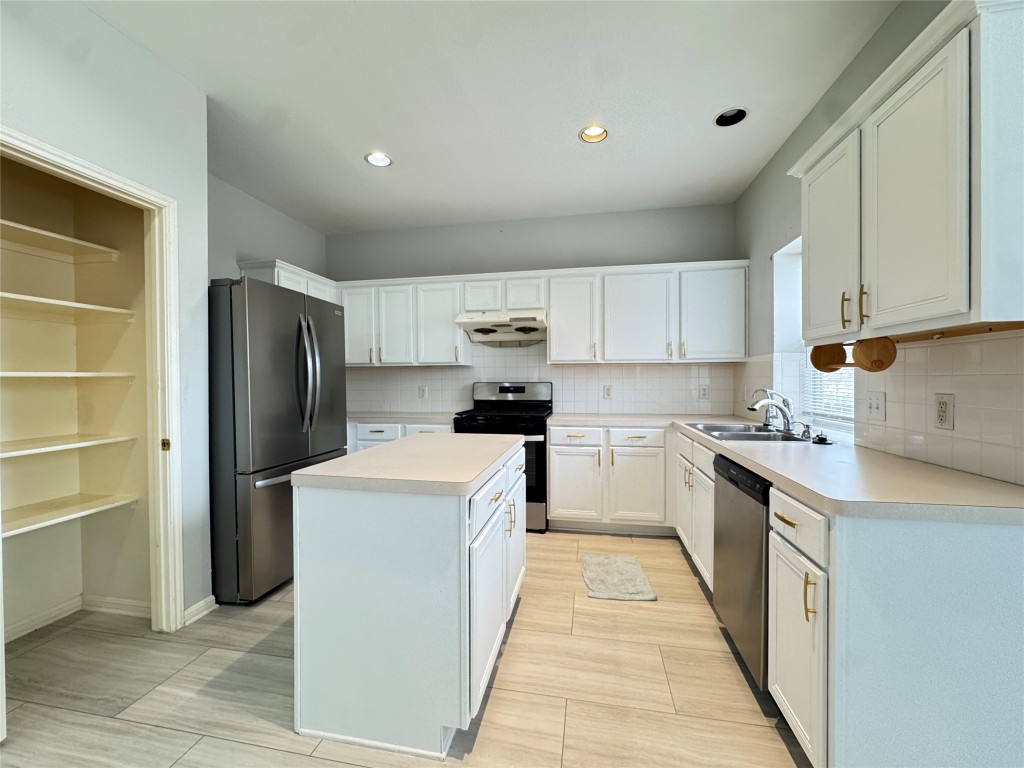 3404 Bratton Ridge Crossing Austin, TX 78728 - Photo 2 of 25 a kitchen with stainless steel appliances a refrigerator sink and white cabinets