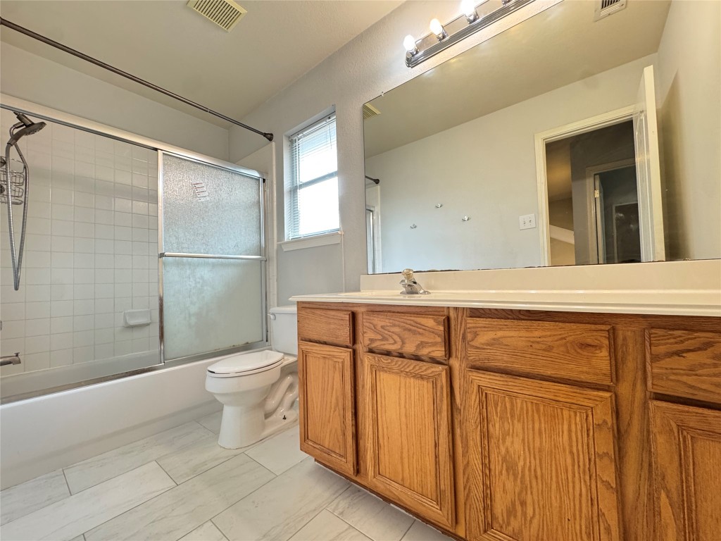 3404 Bratton Ridge Crossing Austin, TX 78728 - Photo 21 of 25 a bathroom with a sink a toilet a mirror and shower