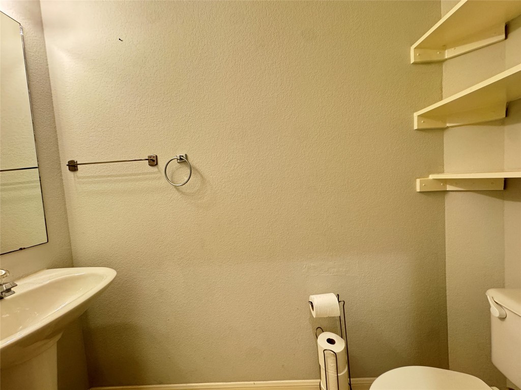 3404 Bratton Ridge Crossing Austin, TX 78728 - Photo 22 of 25 a bathroom with a sink mirror and toilet