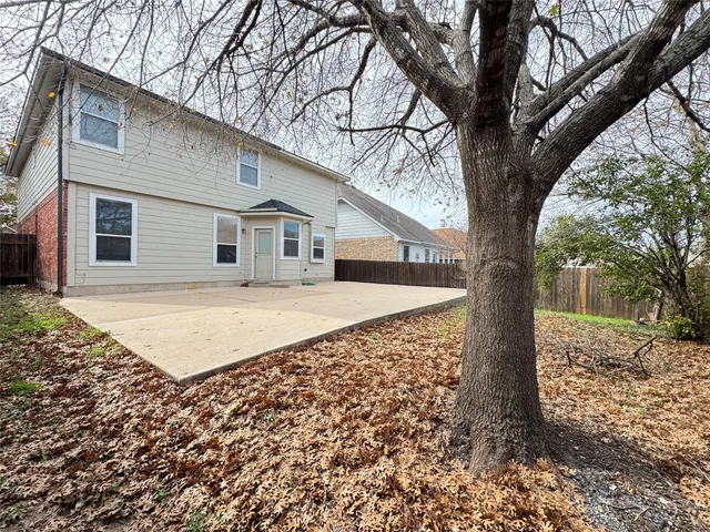 a view of backyard space with wooden fence
