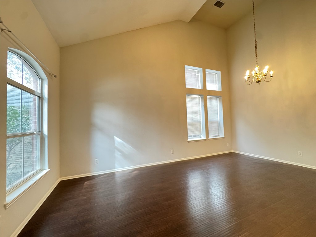 3404 Bratton Ridge Crossing Austin, TX 78728 - Photo 7 of 25 a view of an empty room with wooden floor and a window