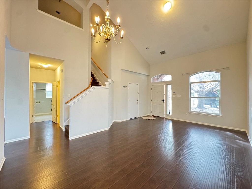 3404 Bratton Ridge Crossing Austin, TX 78728 - Photo 8 of 25 a view of an empty room with wooden floor and a window