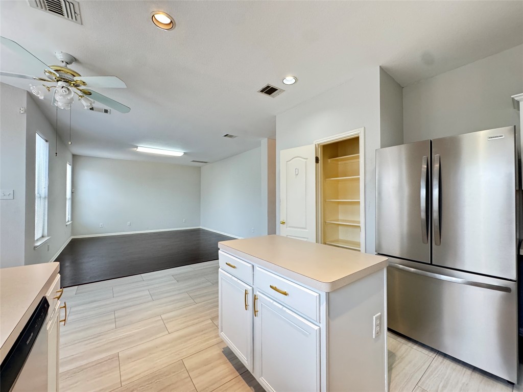 3404 Bratton Ridge Crossing Austin, TX 78728 - Photo 10 of 25 a kitchen with a refrigerator and a sink