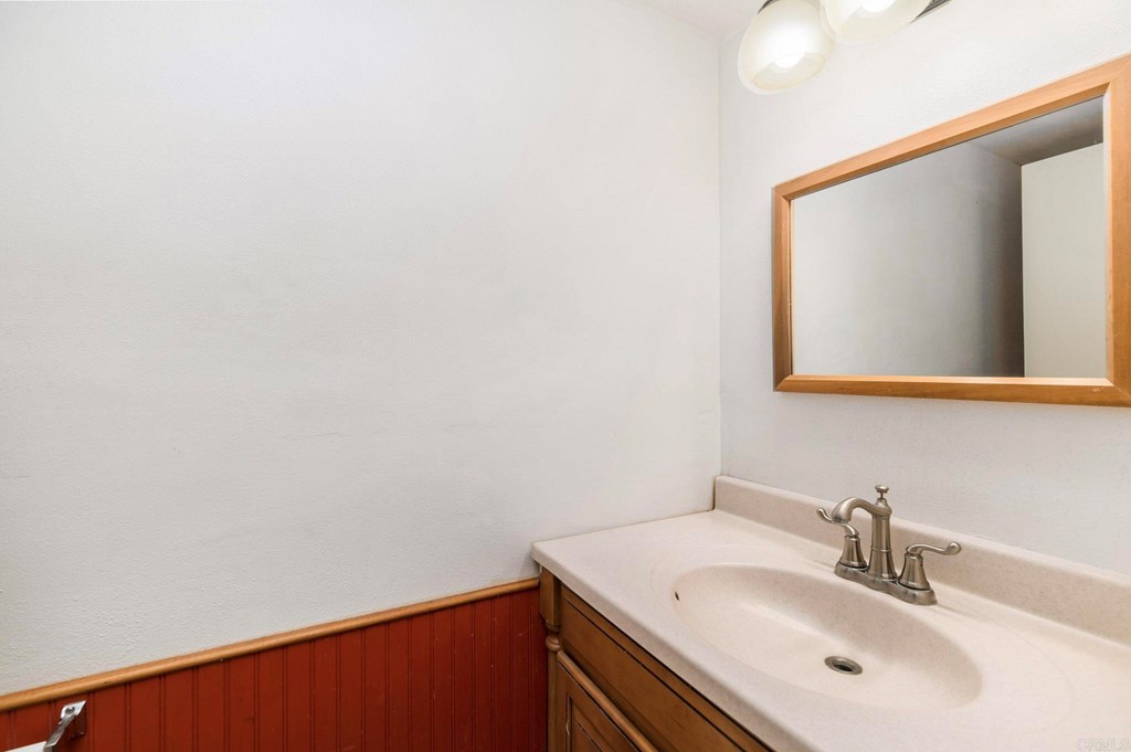 5130 North River Road, Unit F Oceanside, CA 92057 - Photo 11 of 15 a bathroom with a sink and a mirror