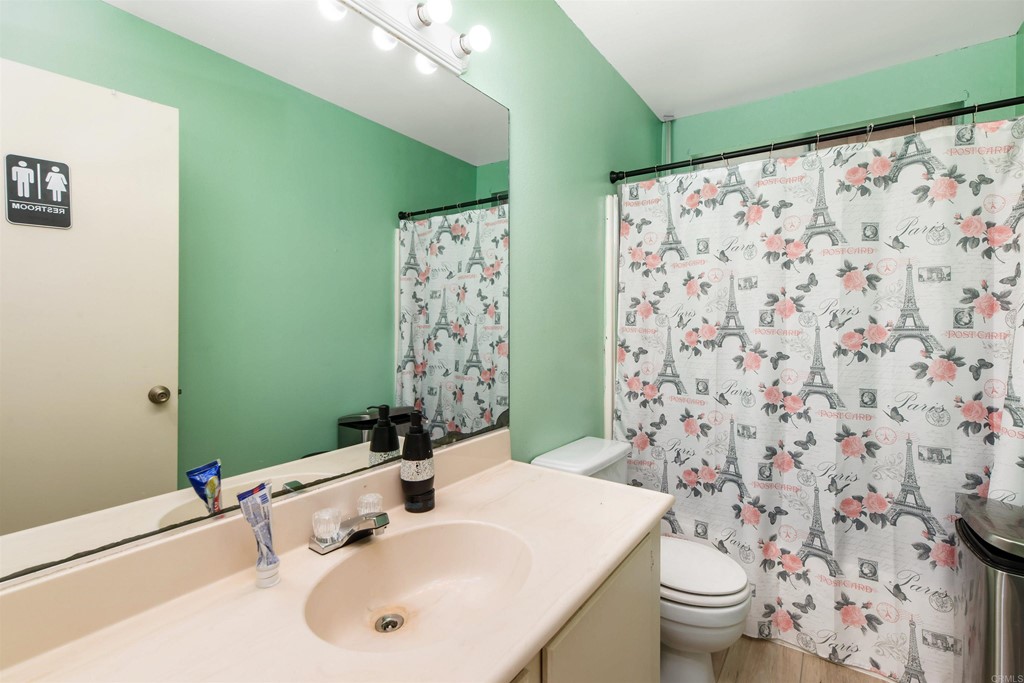 5130 North River Road, Unit F Oceanside, CA 92057 - Photo 9 of 15 a bathroom with a sink toilet and shower