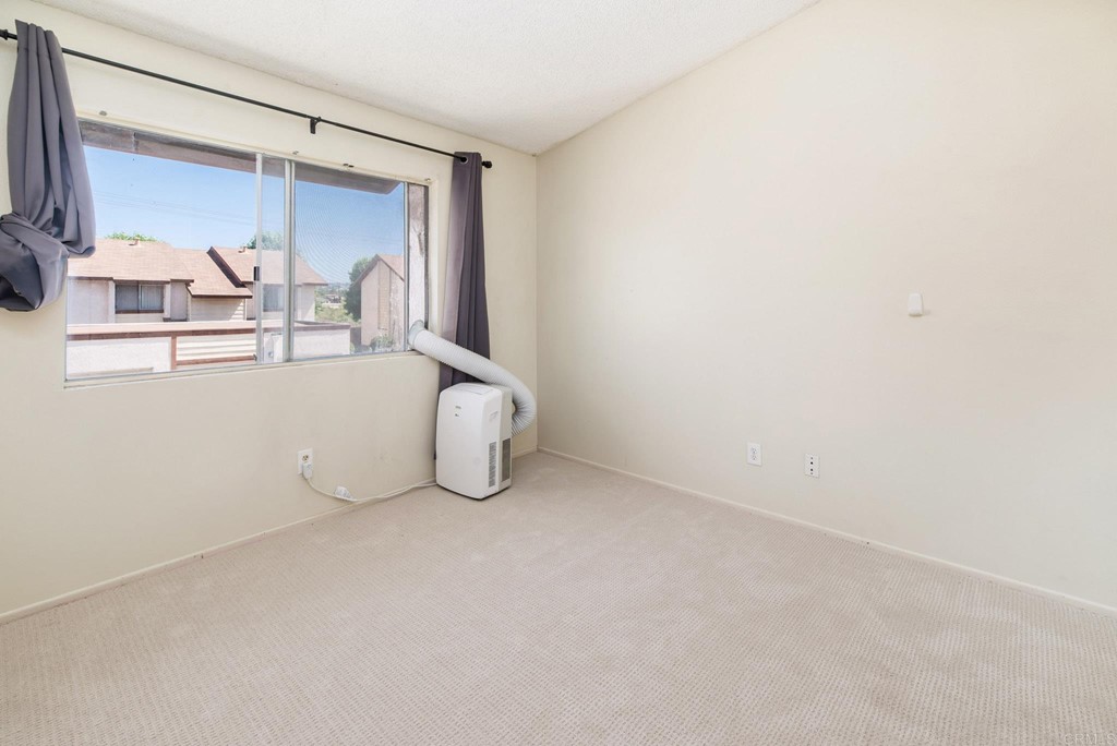 5130 North River Road, Unit F Oceanside, CA 92057 - Photo 10 of 15 a view of an empty room with window