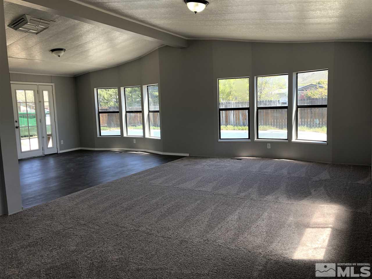 17425 Fantail Street Reno, NV 89508 - Photo 4 of 17 a view of an empty room with wooden floor and a window