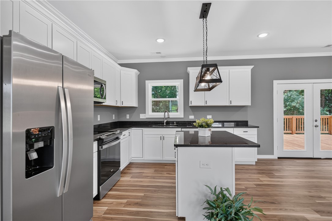 223 Maple Drive Anderson, SC 29621 - Photo 10 of 45 A well-appointed kitchen features stainless steel appliances, dark granite countertops, and direct outdoor access.