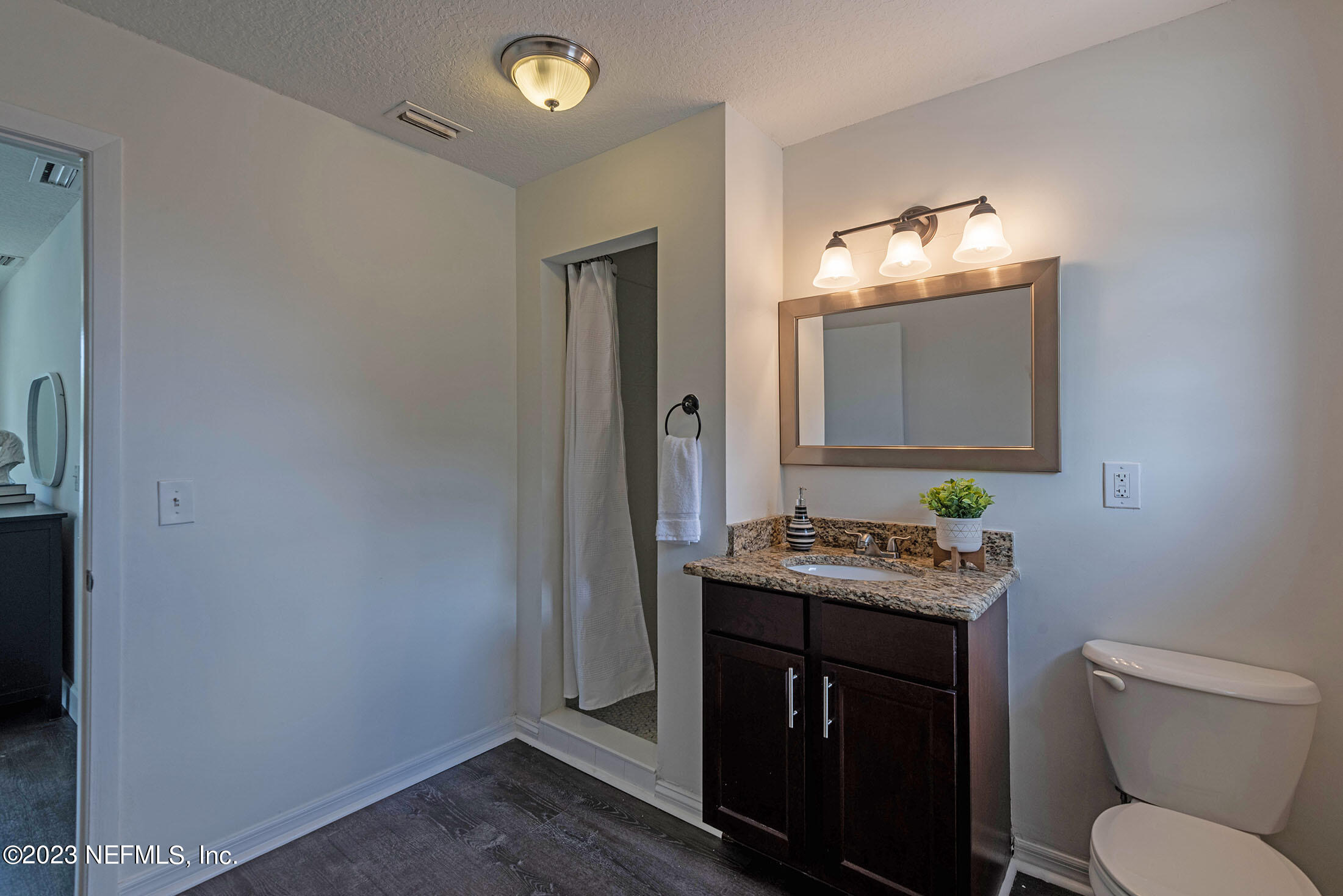 8007 Alderman Road Jacksonville, FL 32211 - Photo 37 of 63 a bathroom with a toilet sink and mirror