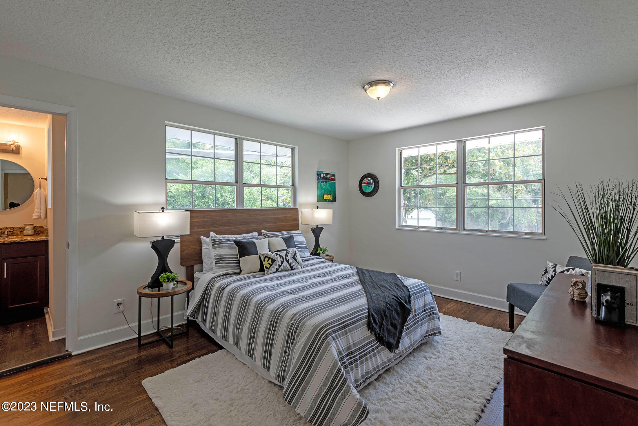 8007 Alderman Road Jacksonville, FL 32211 - Photo 43 of 63 a bedroom with a bed a bookshelf a potted plant and a window
