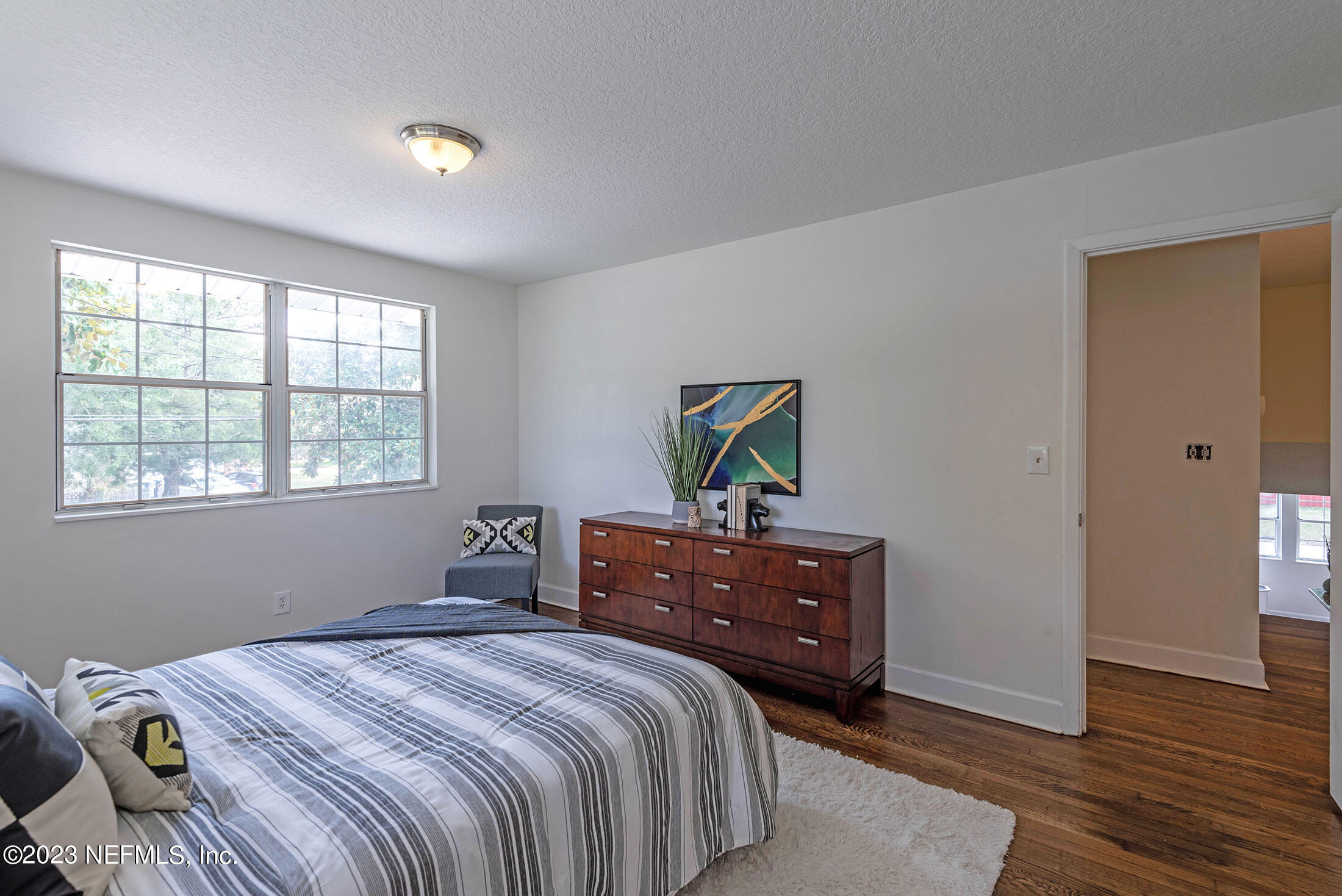 8007 Alderman Road Jacksonville, FL 32211 - Photo 44 of 63 a bedroom with a bed and wooden floor