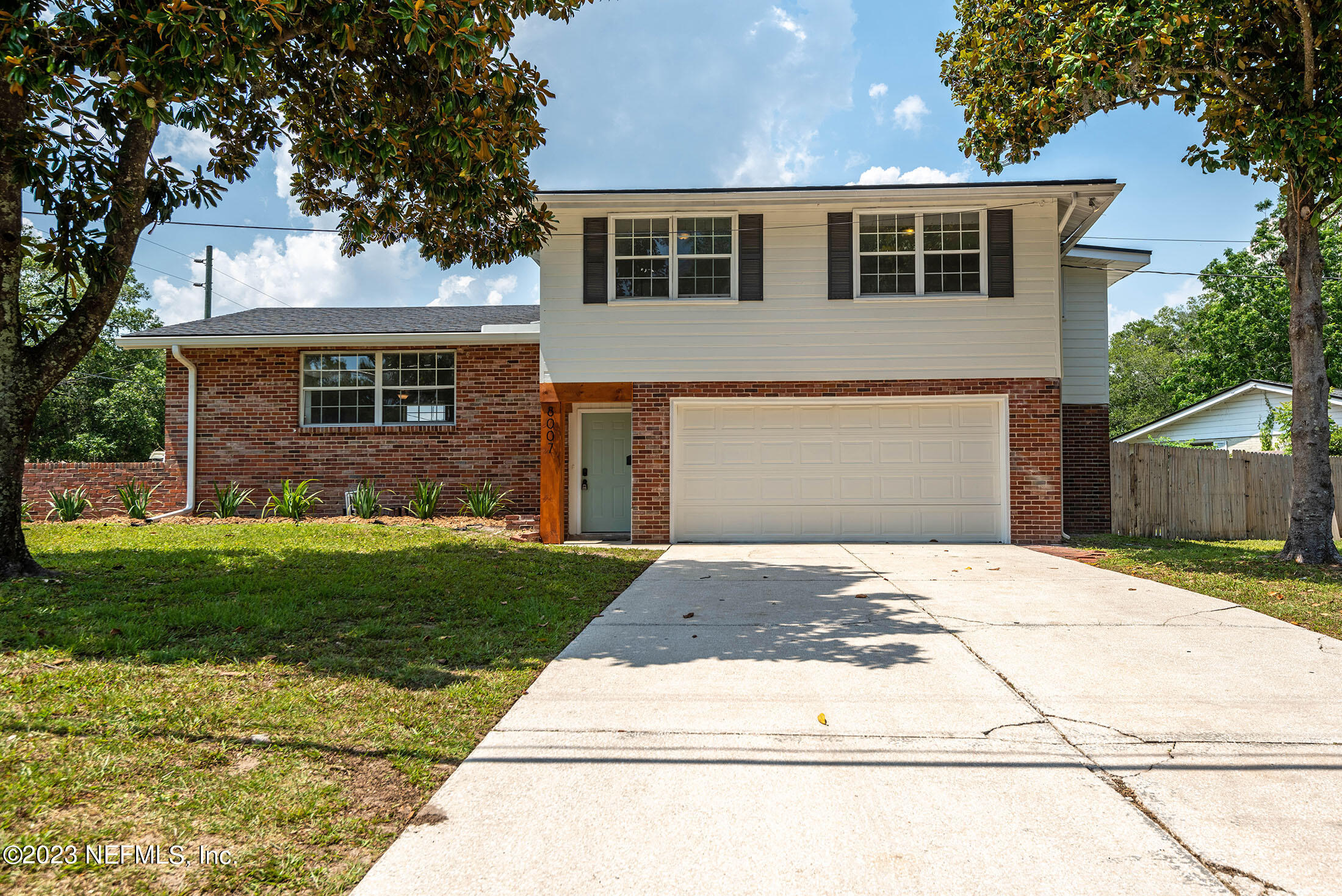 8007 Alderman Road Jacksonville, FL 32211 - Photo 57 of 63 a front view of a house with a yard and garage
