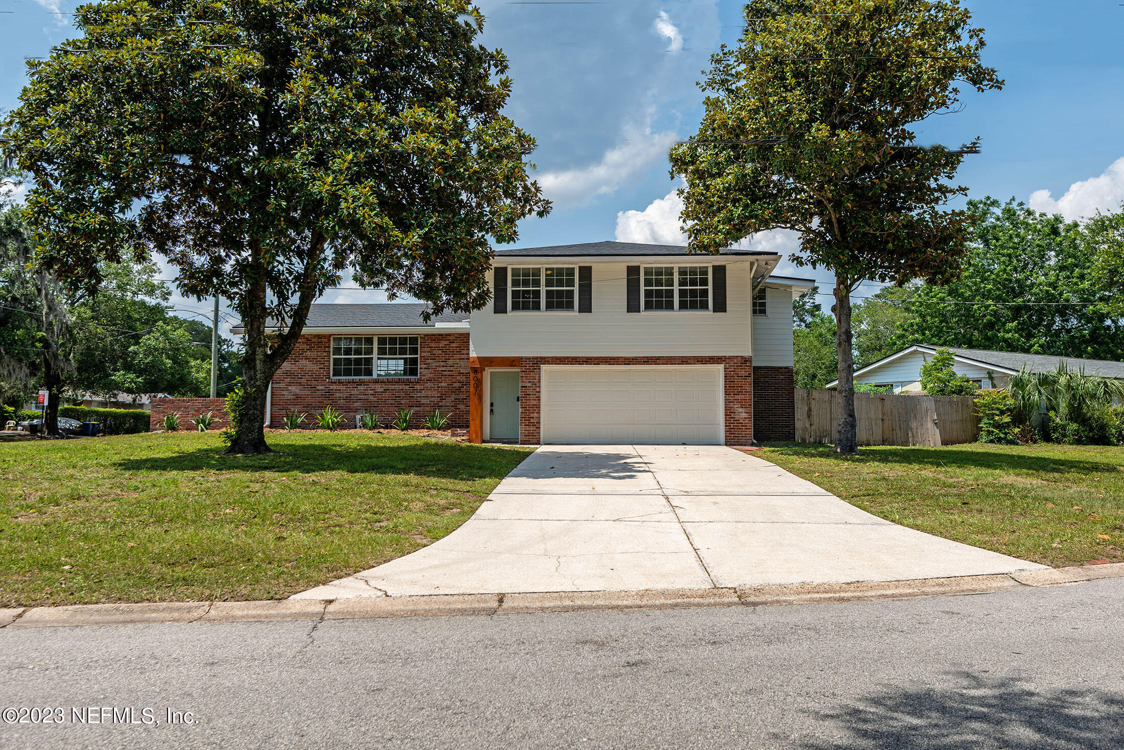 8007 Alderman Road Jacksonville, FL 32211 - Photo 58 of 63 a front view of a house with a yard and trees