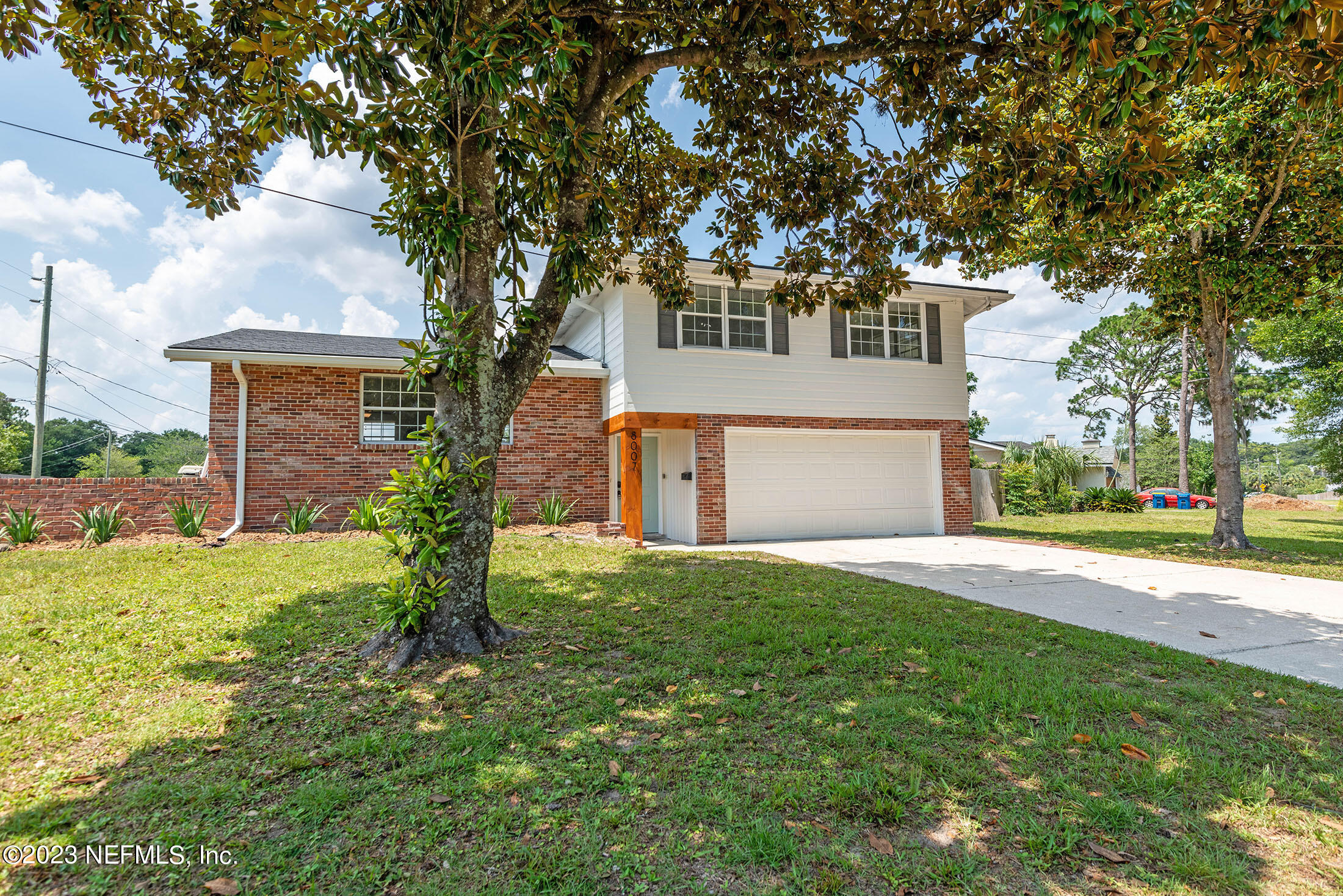 8007 Alderman Road Jacksonville, FL 32211 - Photo 63 of 63 a front view of a house with a yard and garage