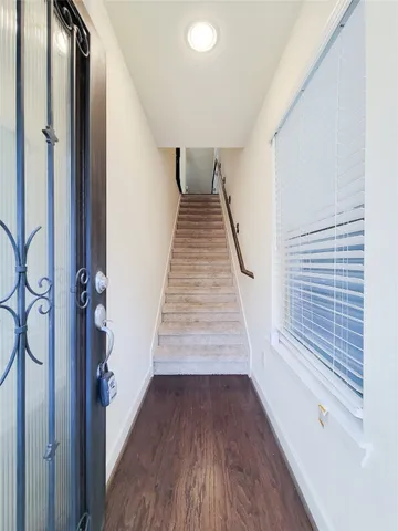 a view of a hallway view with wooden floor and staircase