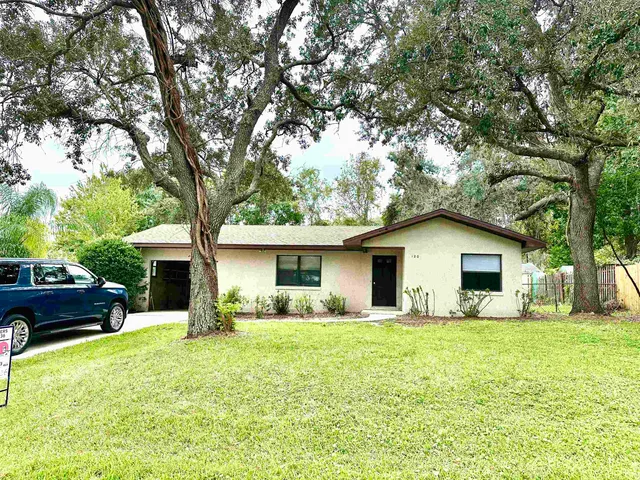 a front view of house with yard and green space