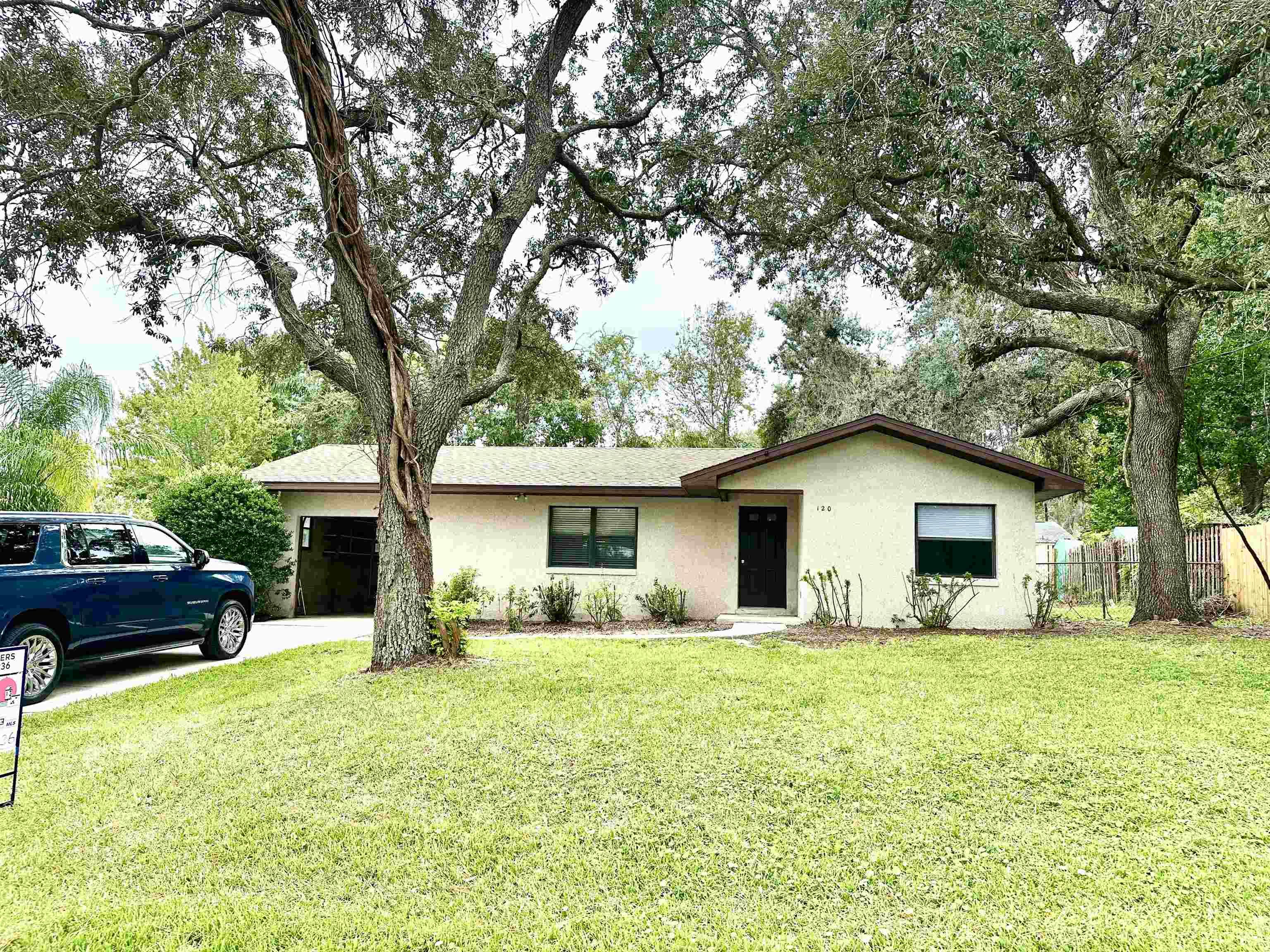 a front view of house with yard and green space