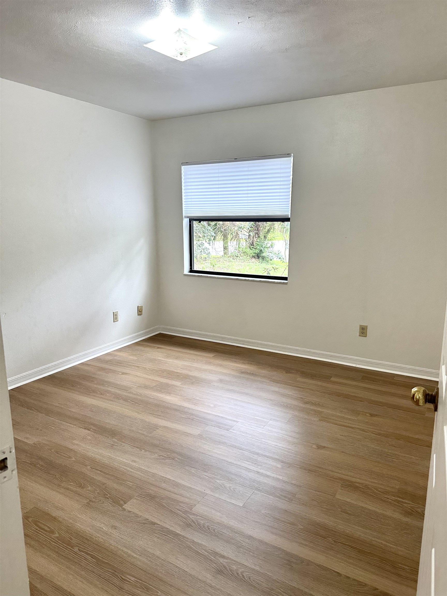 120 Vassar Road St. Augustine South, FL 32086 - Photo 12 of 24 an empty room with wooden floor and windows