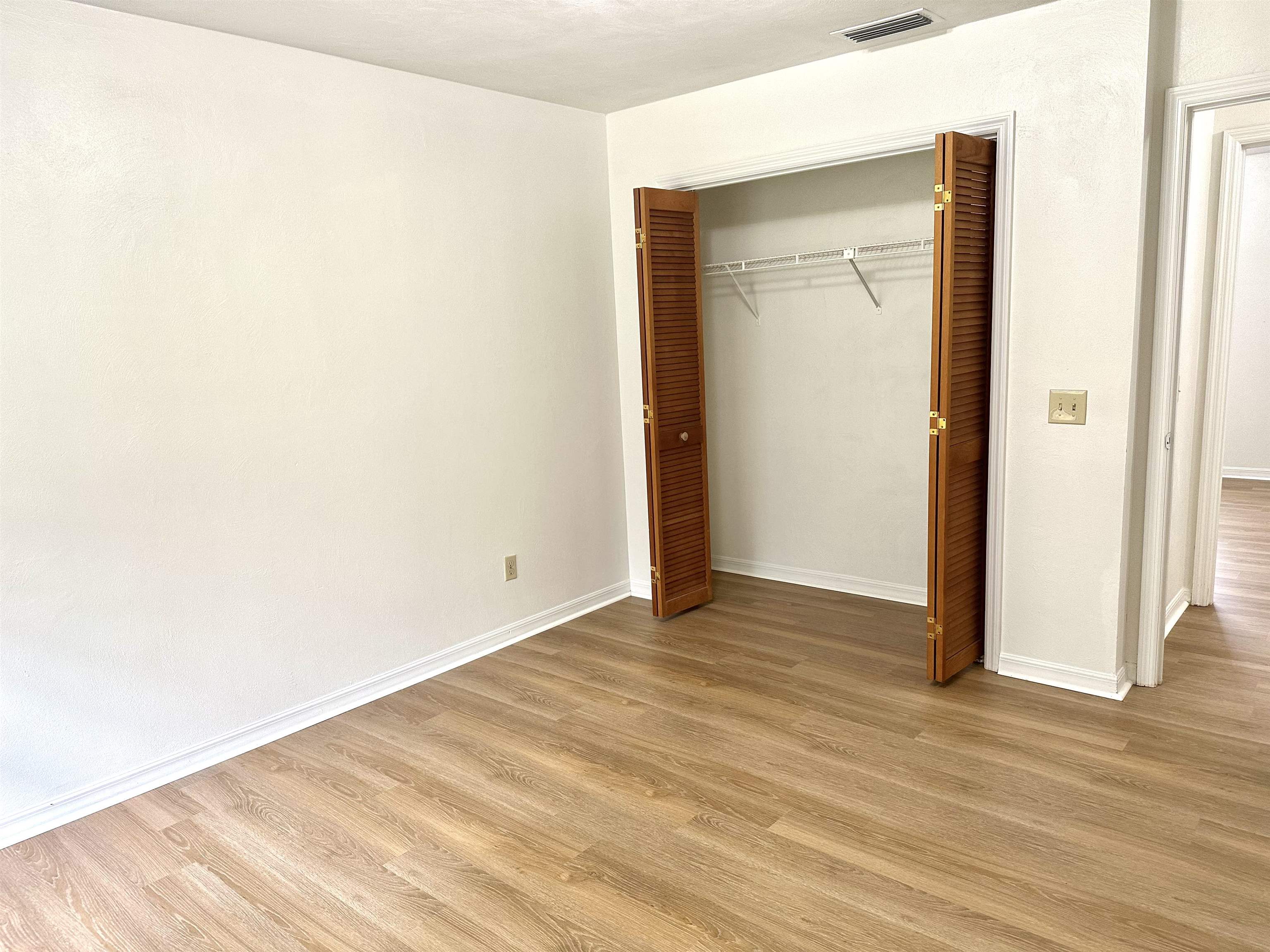 120 Vassar Road St. Augustine South, FL 32086 - Photo 15 of 24 a view of an empty room with wooden floor and a window