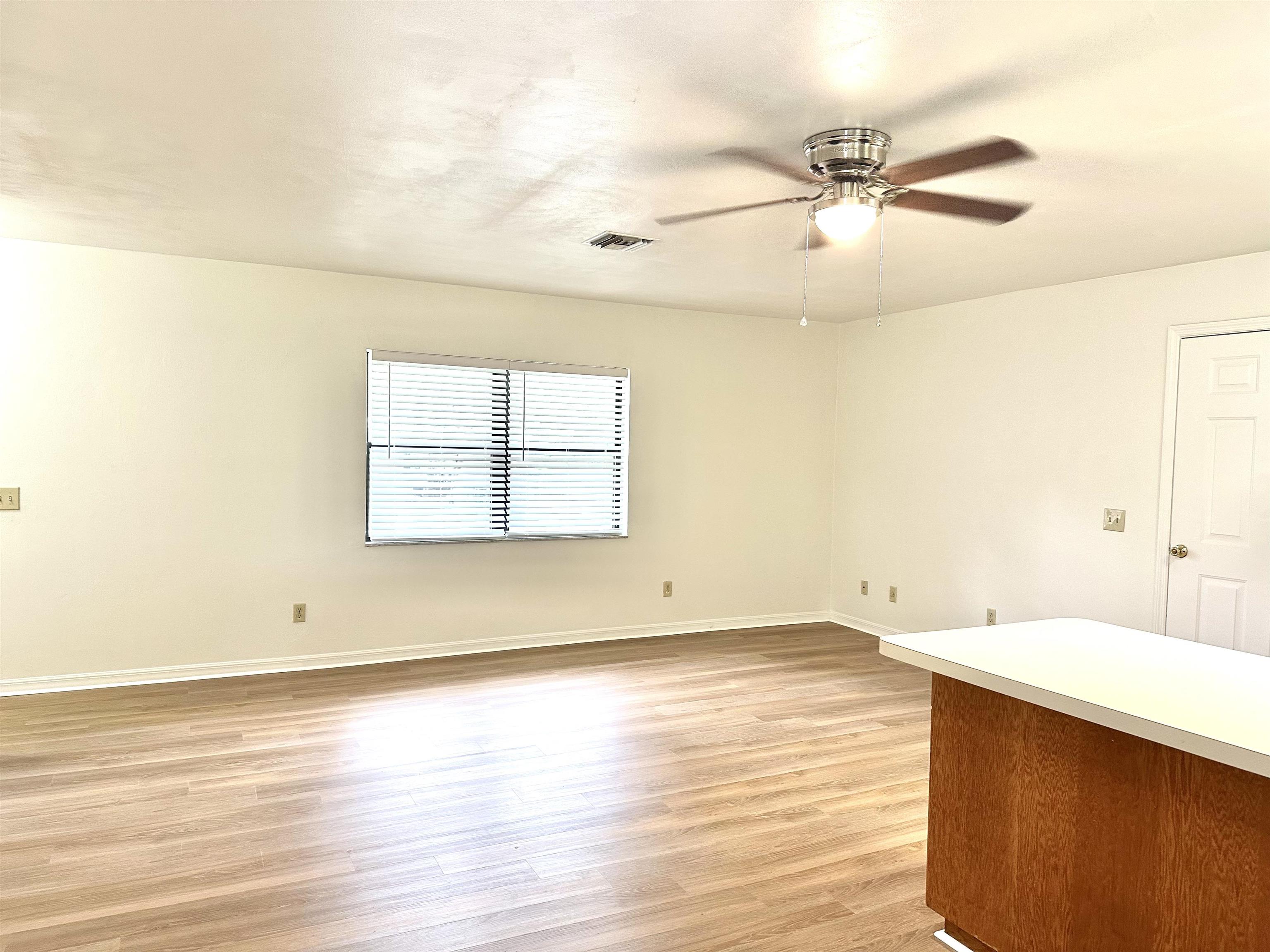 120 Vassar Road St. Augustine South, FL 32086 - Photo 4 of 24 an empty room with wooden floor and windows