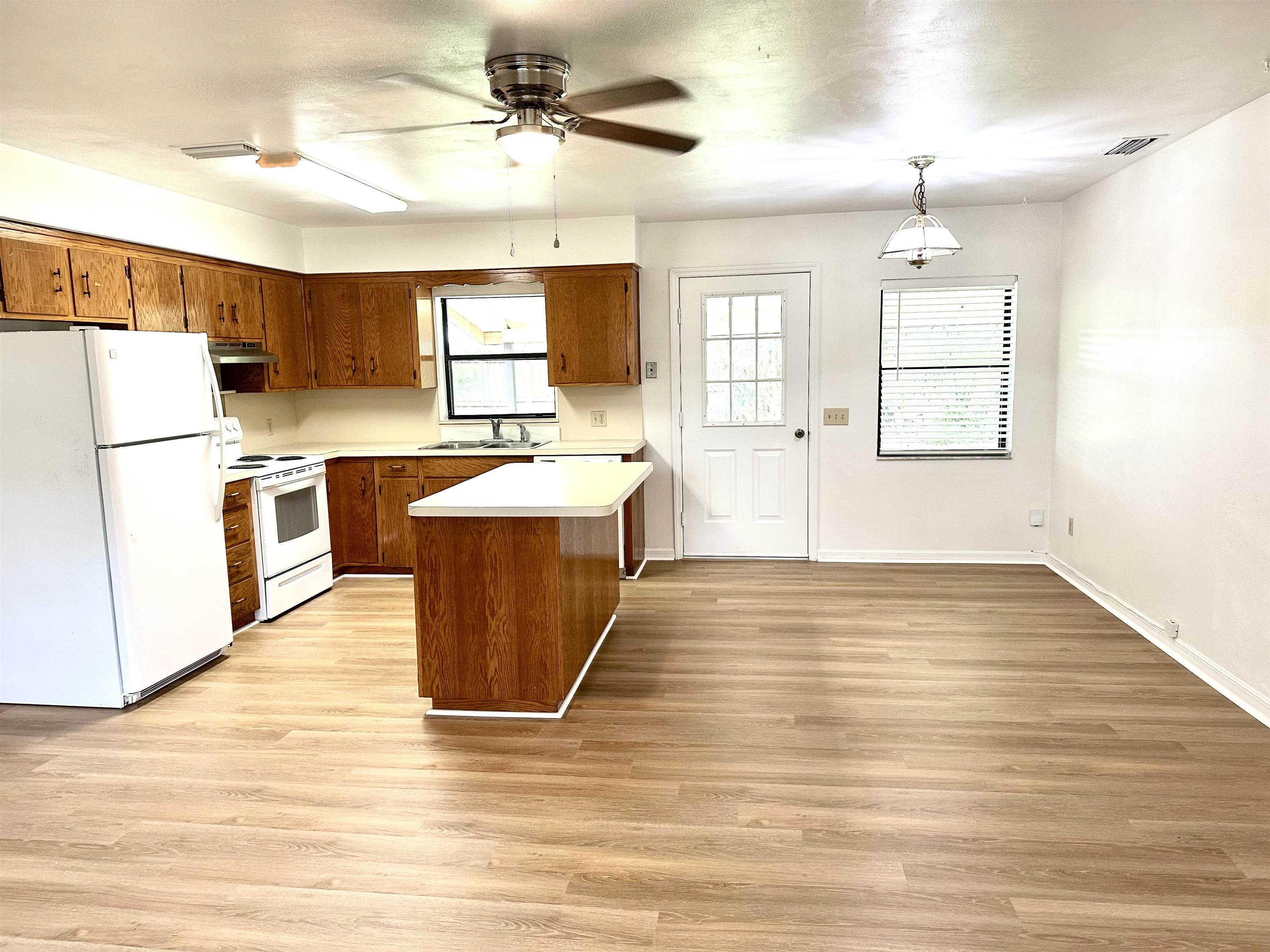 120 Vassar Road St. Augustine South, FL 32086 - Photo 5 of 24 a large kitchen with cabinets wooden floor and stainless steel appliances