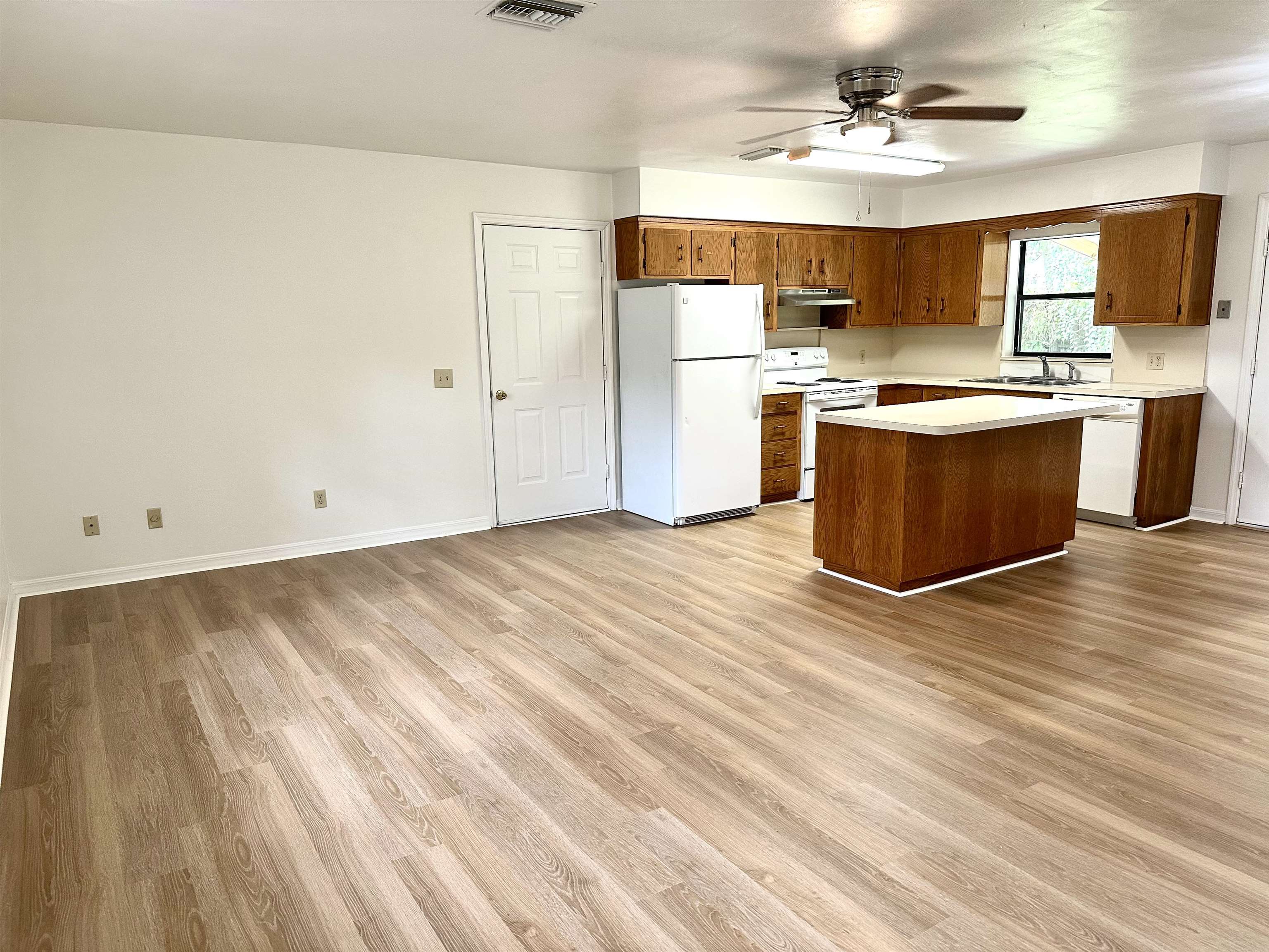 120 Vassar Road St. Augustine South, FL 32086 - Photo 6 of 24 a large kitchen with stainless steel appliances a large counter top a stove a refrigerator with white cabinets and wooden floor
