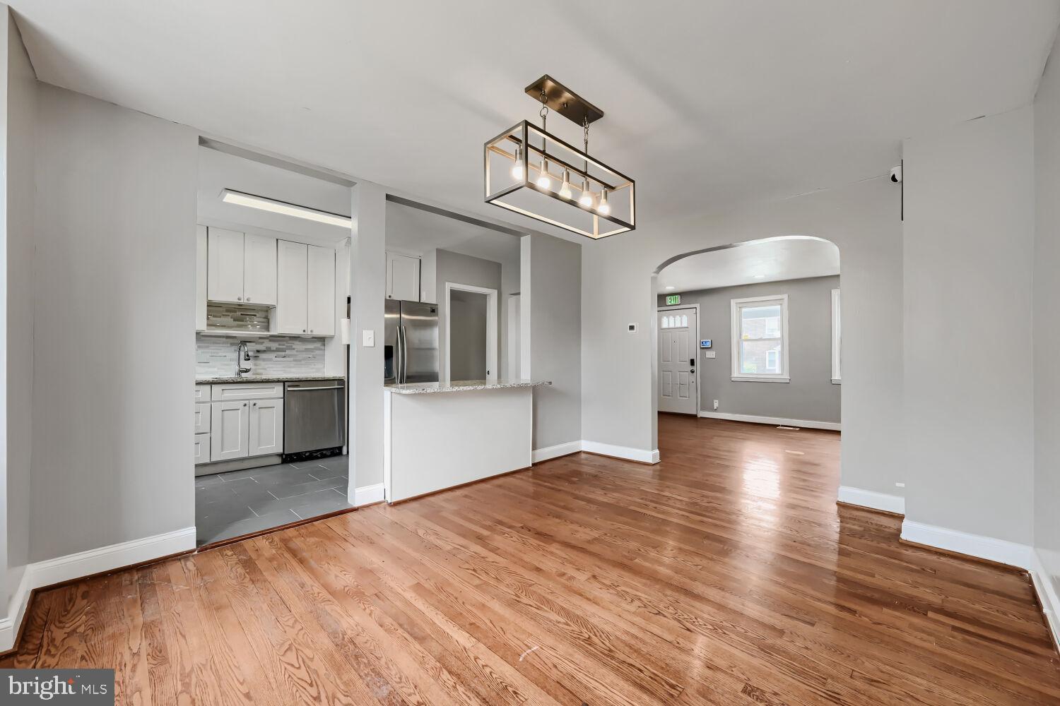 1014 Lyndhurst Street Baltimore, MD 21229 - Photo 11 of 29 a view of a kitchen with a sink a refrigerator and wooden floor