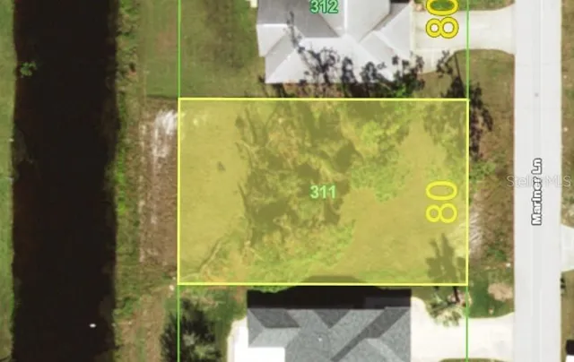 an aerial view of residential house with outdoor space and parking