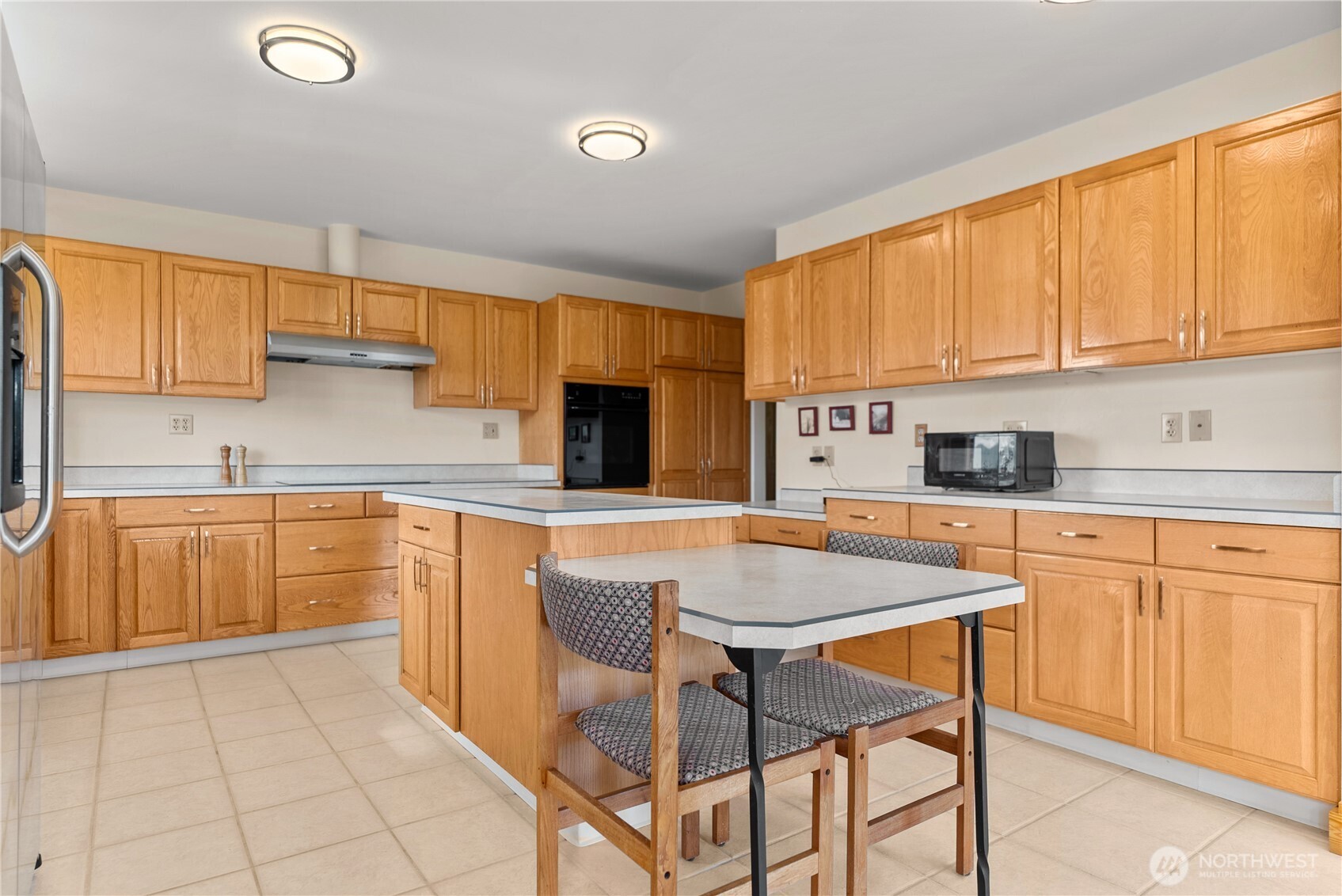 427 Rendezvous Road Winthrop, WA 98862 - Photo 22 of 40 a kitchen with stainless steel appliances granite countertop a stove a sink dishwasher and a refrigerator with wooden cabinets