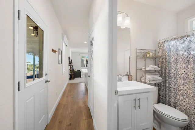 a bathroom with a sink a toilet and shower