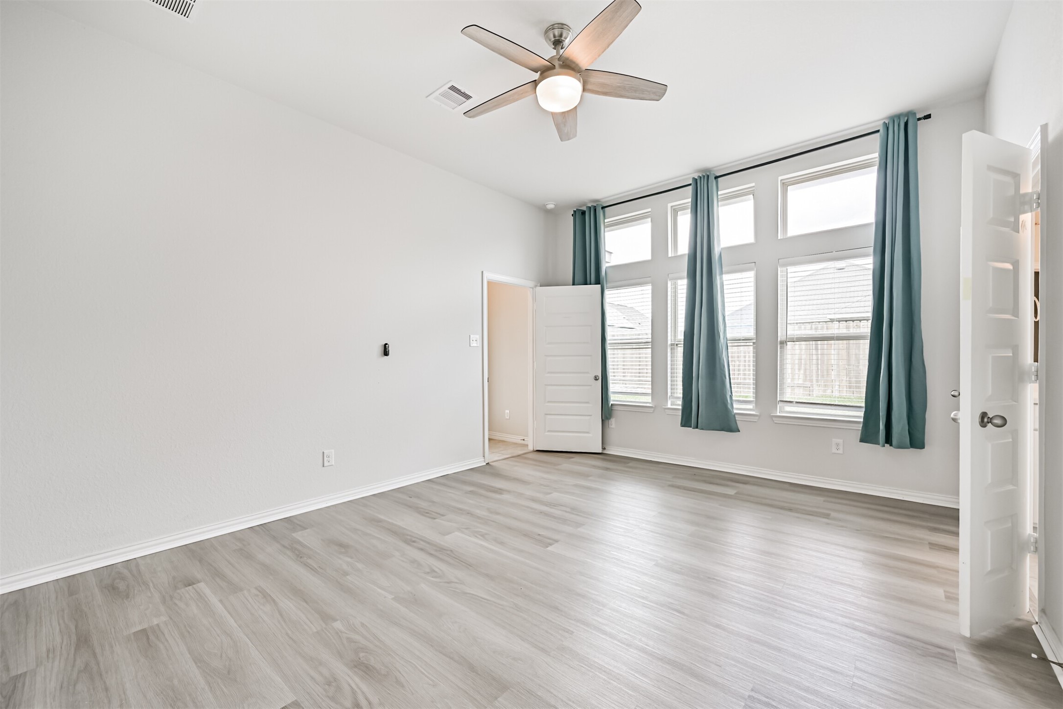 7019 Terra Drive Manvel, TX 77578 - Photo 33 of 41 a view of an empty room with a window and wooden floor