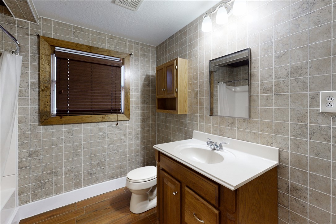 903 Travis Street Bryan, TX 77803 - Photo 14 of 20 a bathroom with a sink a toilet and mirror