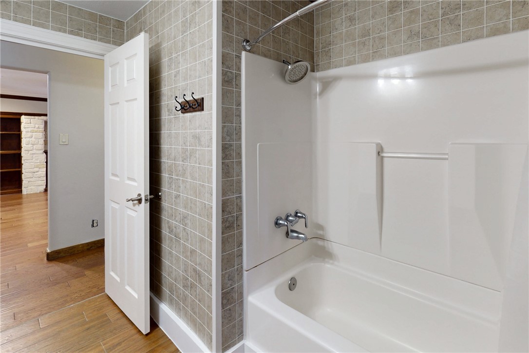 903 Travis Street Bryan, TX 77803 - Photo 15 of 20 a bathroom with a bathtub