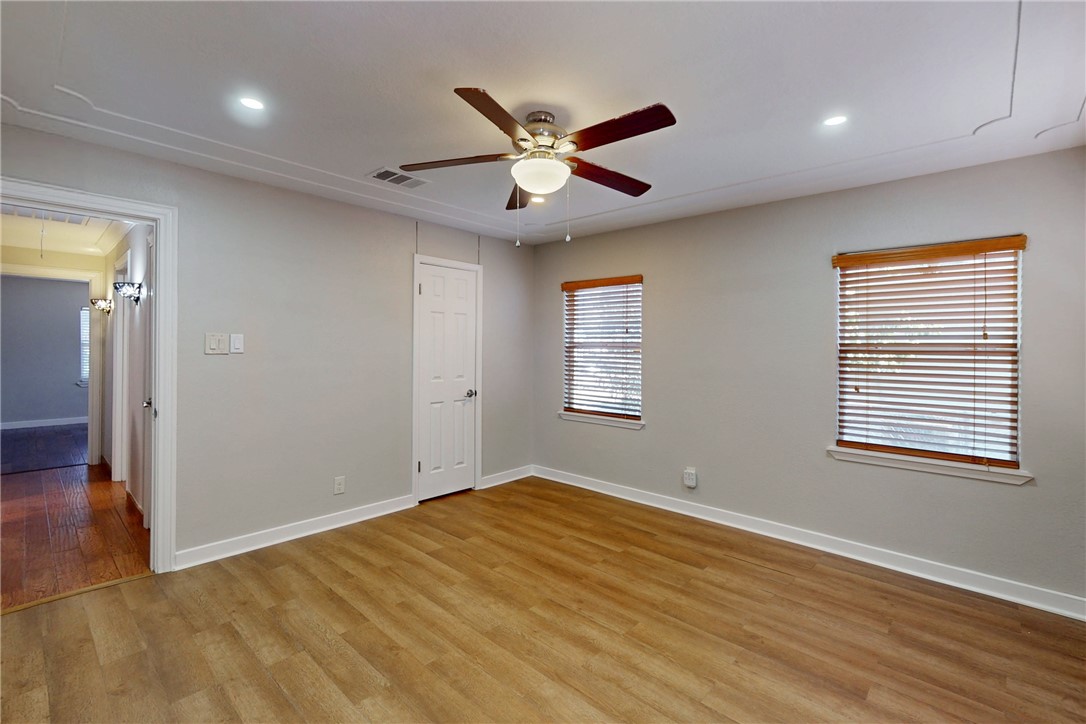 903 Travis Street Bryan, TX 77803 - Photo 17 of 20 a view of an empty room with window and wooden floor